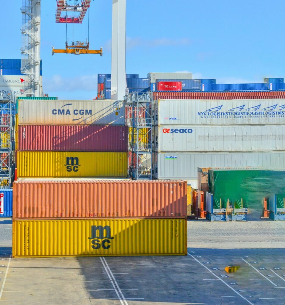Cargo containers at shipping port representing international logistics by WAVE Customs Brokerage